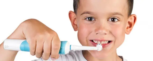 child using an electric toothbrush
