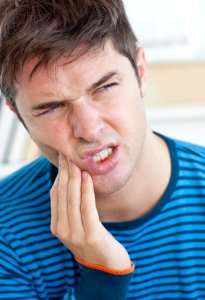 man with painful tooth