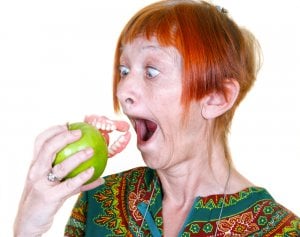 woman losing false teeth