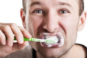 man brushing teeth