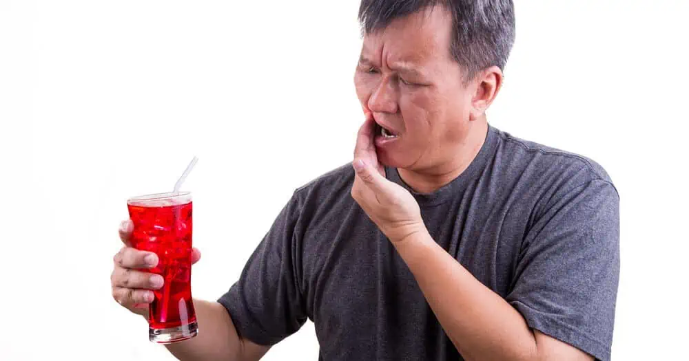 man with cold drink and painful tooth