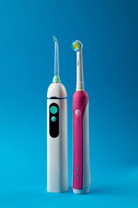 Electric toothbrush and oral irrigator to remove plaque