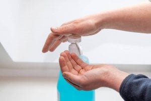 using hand sanitizer at the dentist