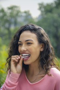 woman using invisalign lite to fix crowded teeth