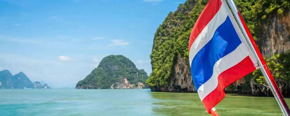 View of Thai islands and flag from a boat