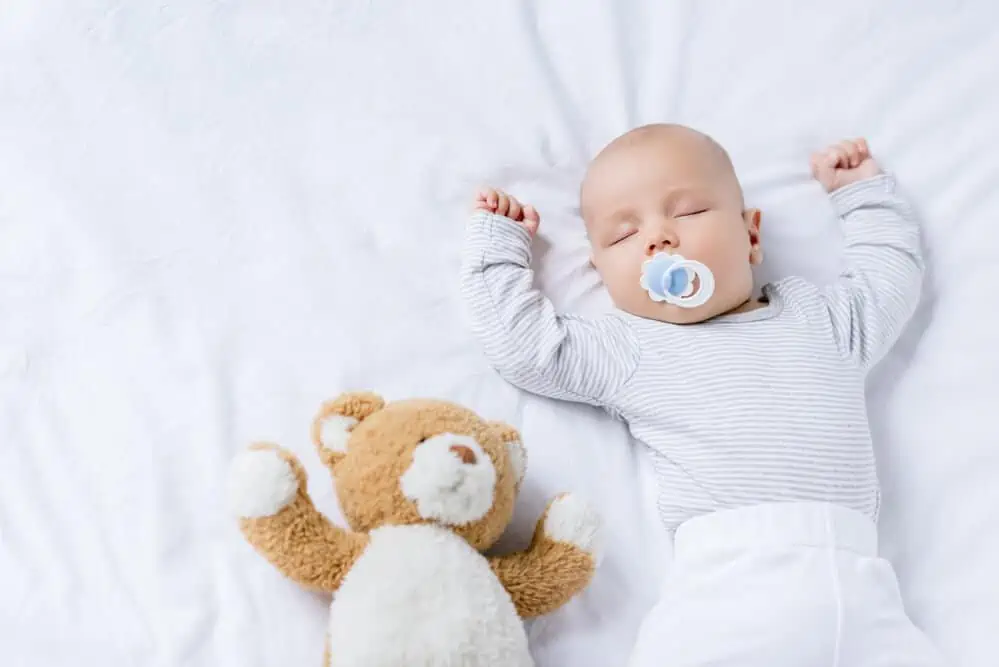 Child sleeping with a pacifier in mouth