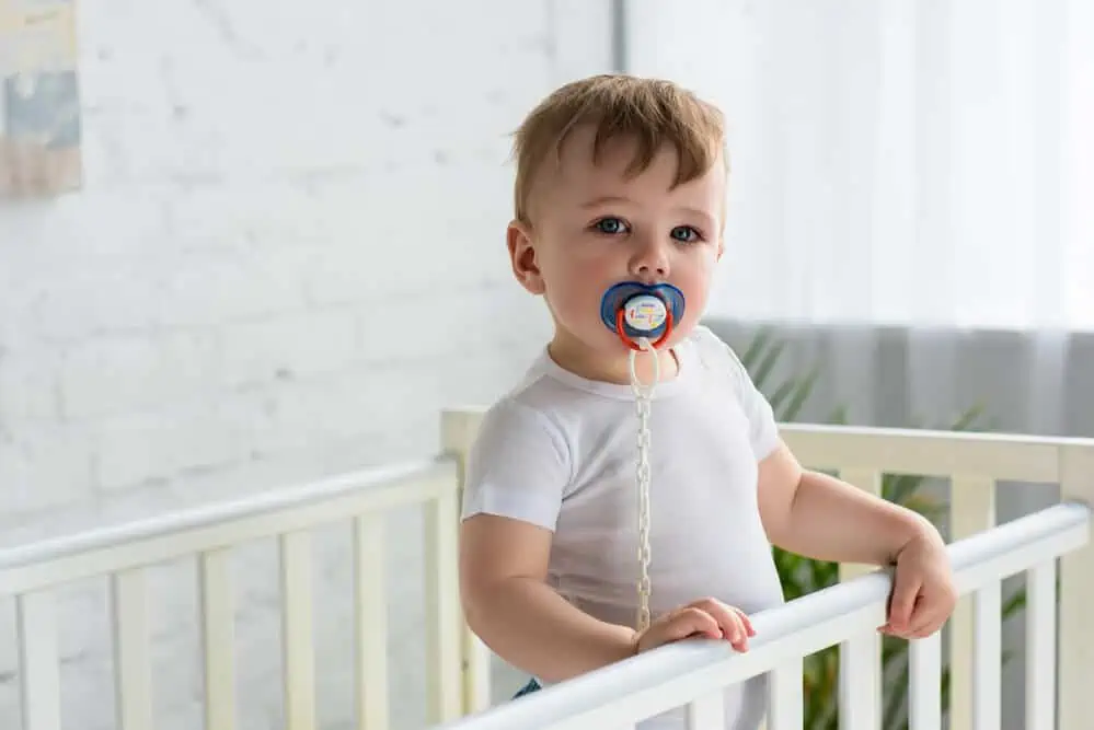 Child sucking a pacifier