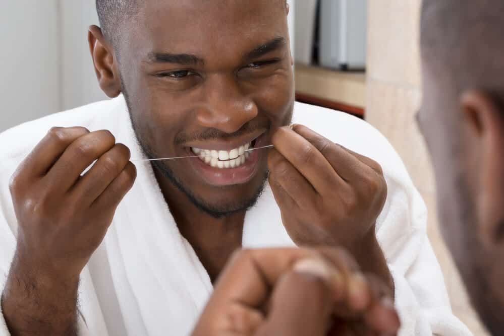 Man flossing teeth