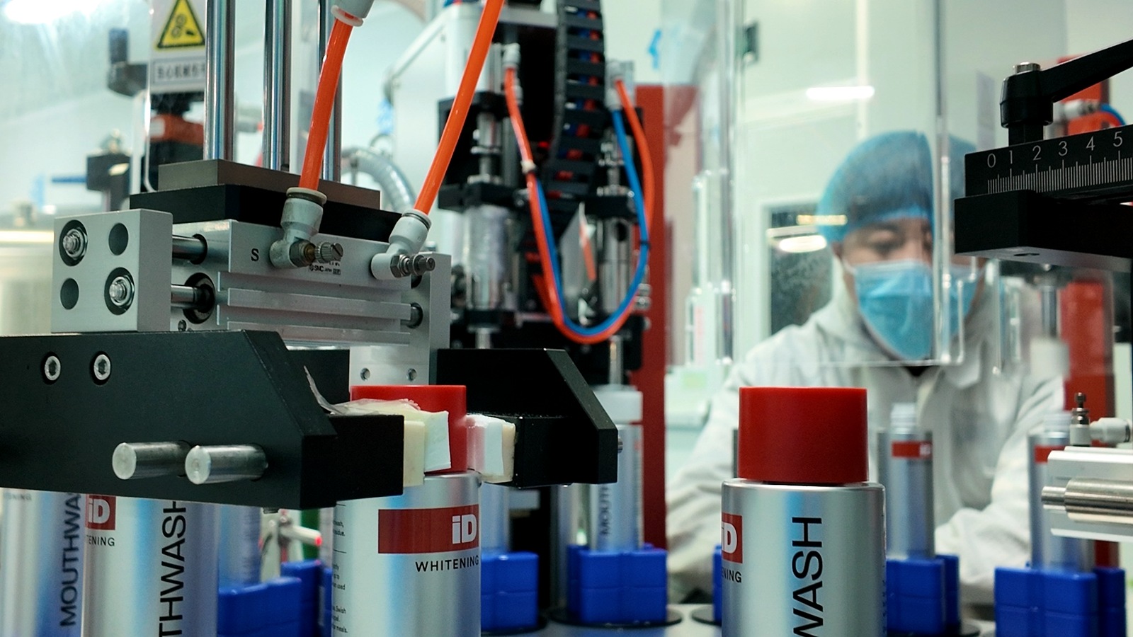Commercial bottle filling and line handling at ORALABX's Xiamen oral-care production facility.