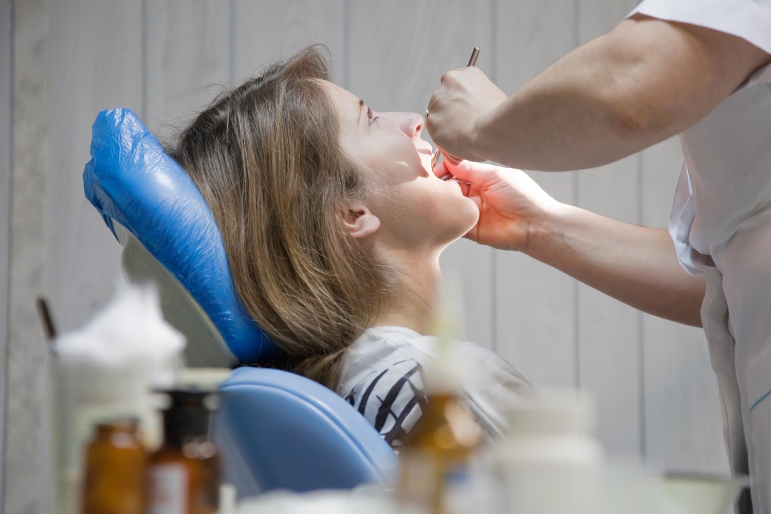 Dentist examining a patient's periodontal and dental implant health