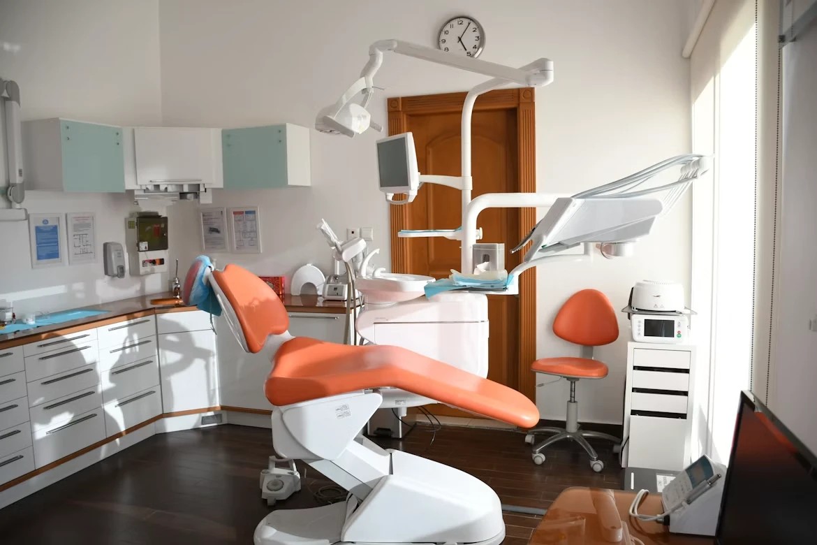 Modern dental treatment room with orange dental chair