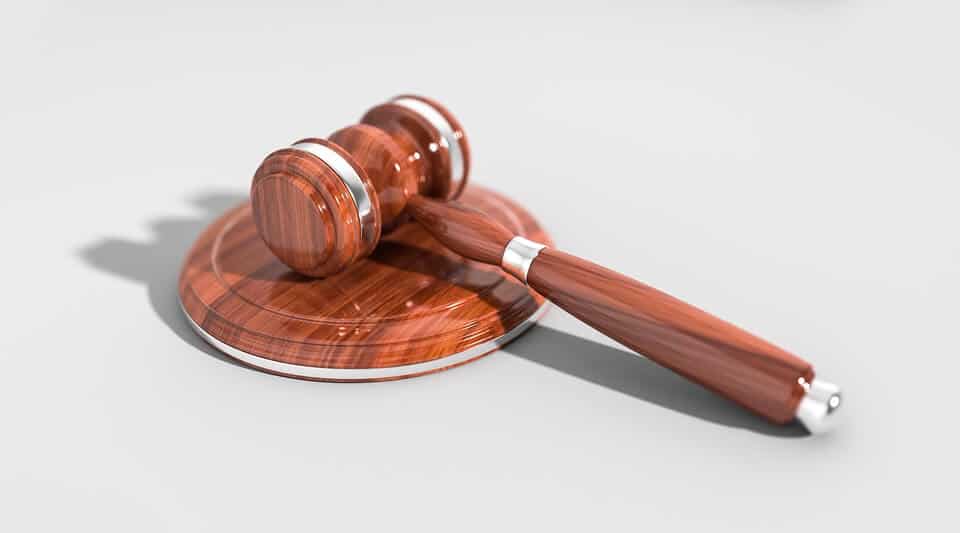 Wooden gavel resting on a circular base, symbolizing justice and authority in a courtroom setting.