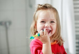 Petite fille et brosse à dents